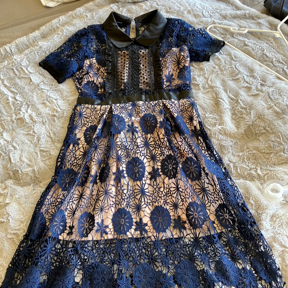 Navy guipure midi dress with empire waist and black satin collar.